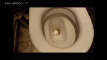 Extremely attractive blond woman defecating in the bathroom